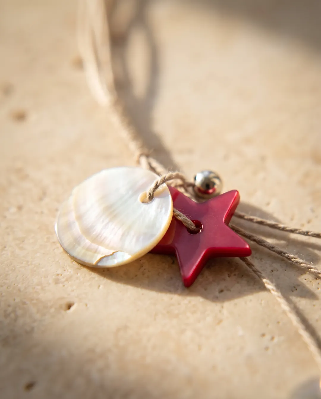 Shell and starfish necklace on warm sand