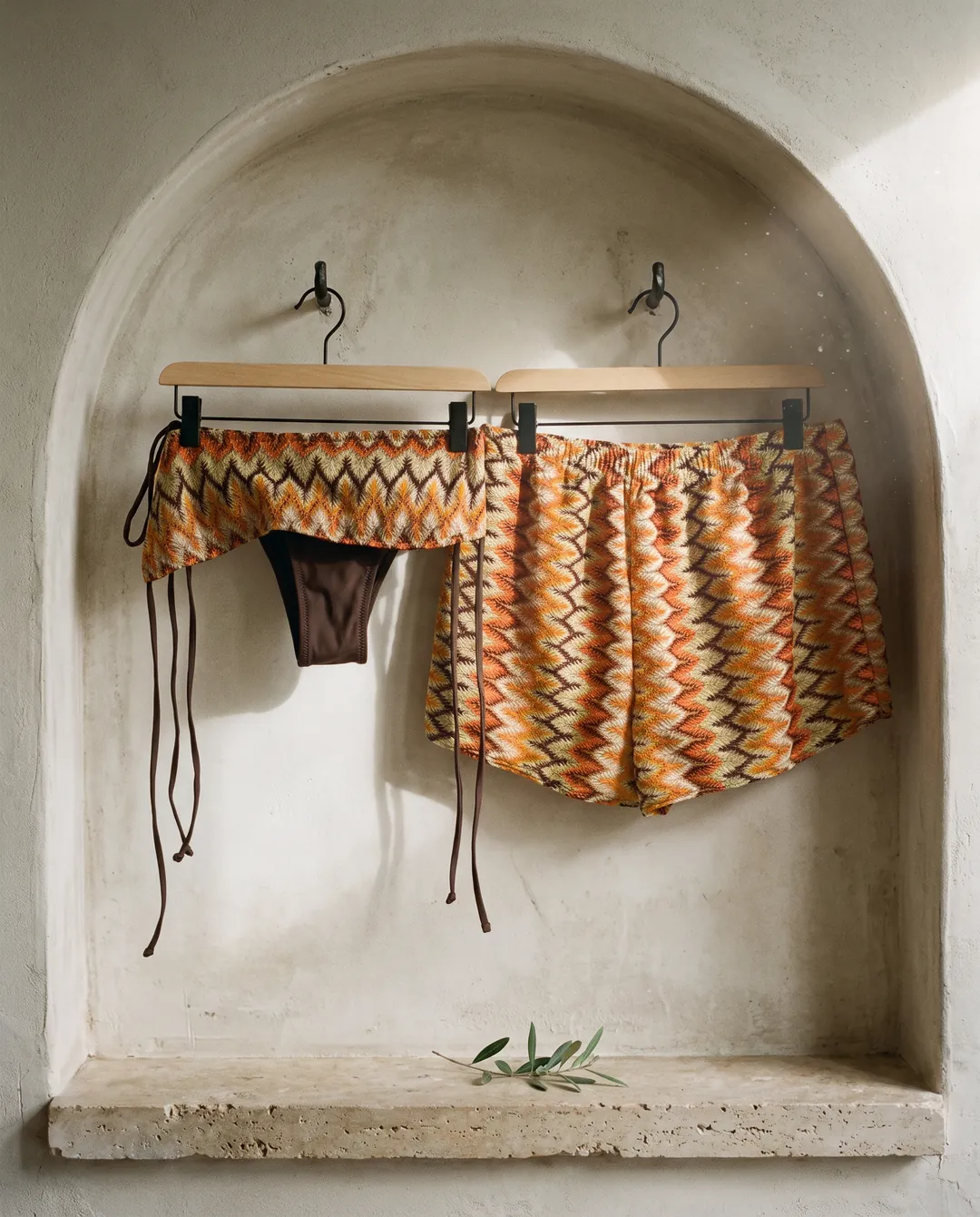 Patterned swimwear hanging in a stone alcove